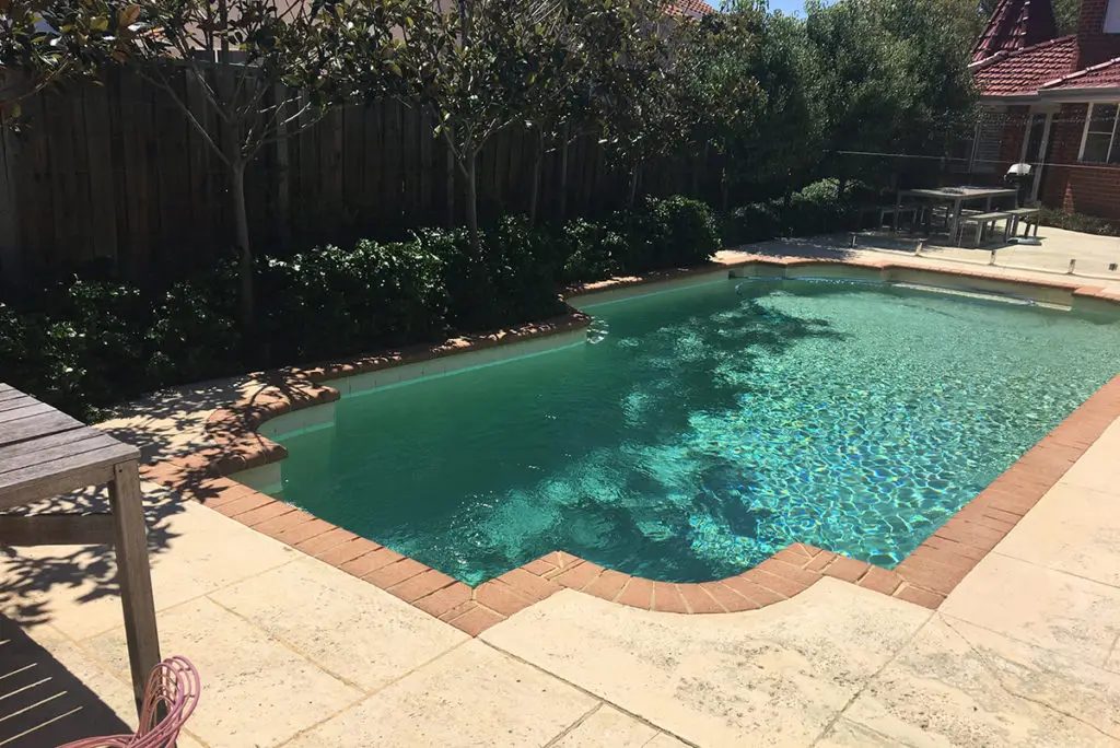 A before photo of the pool and surrounding areas.