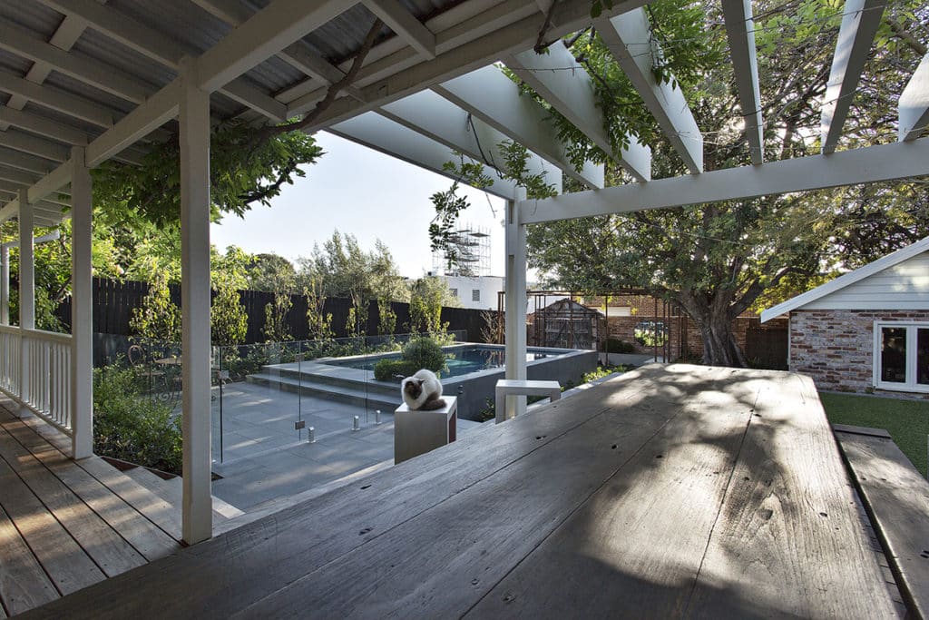 A patio, landscape and elevated concrete pool at a Perth heritage home.